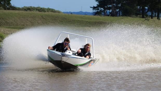 A jetsprint boat speeding across the water